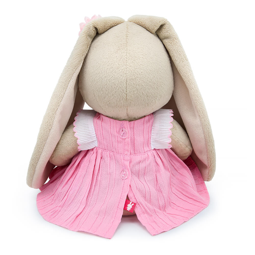 in a dress with a lavender bow