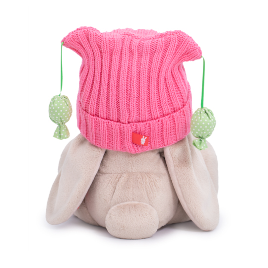 in a pink hat with pompons