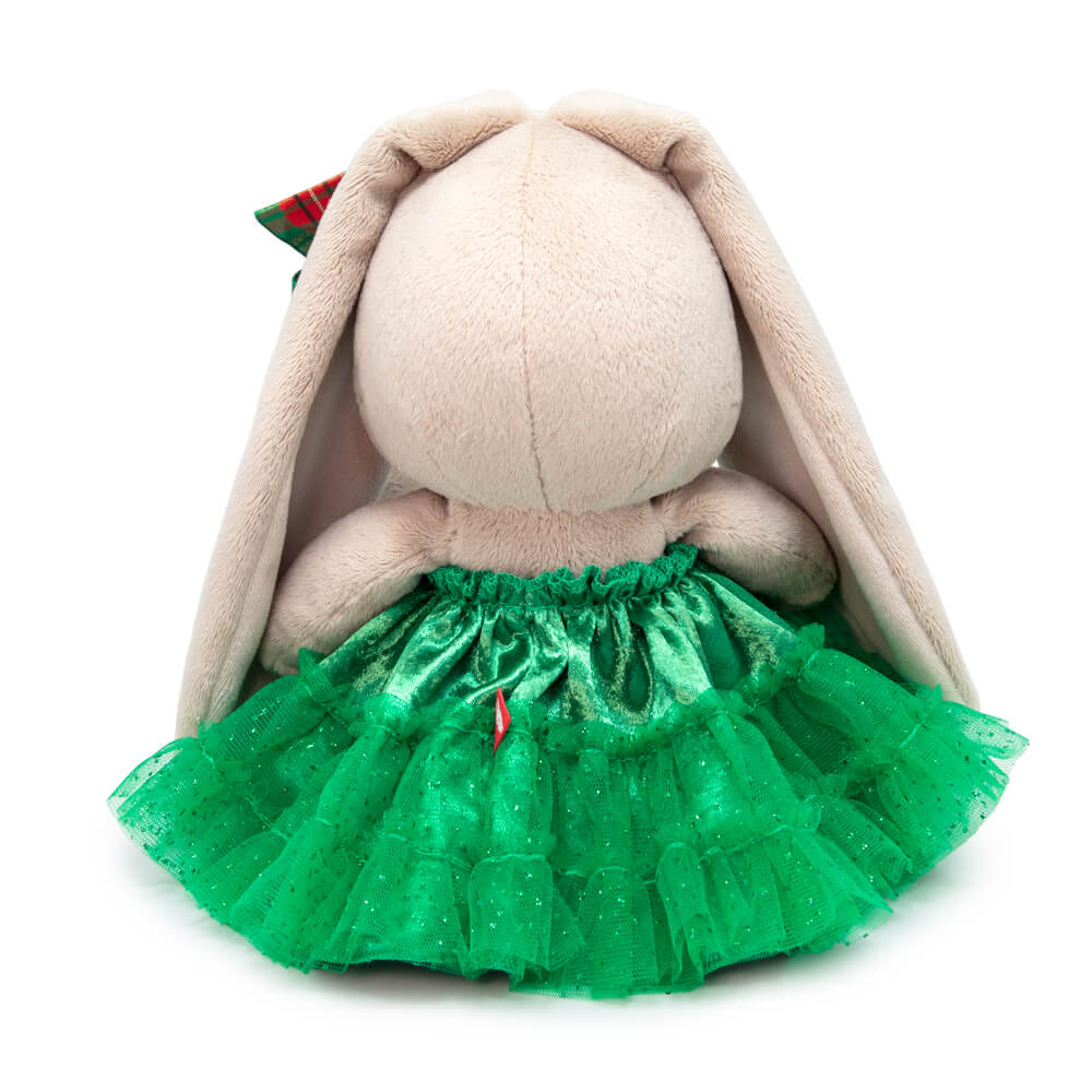 in a green skirt with a bow