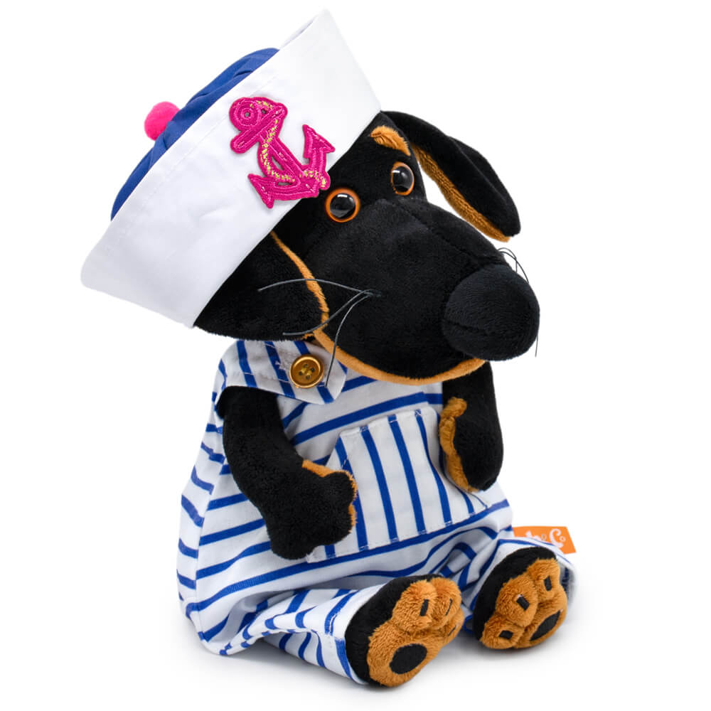 in a striped overalls and a panama hat with an anchor