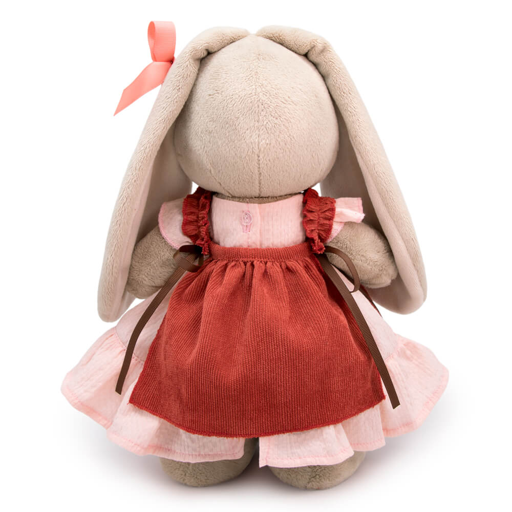 in a dress and apron with ruffles