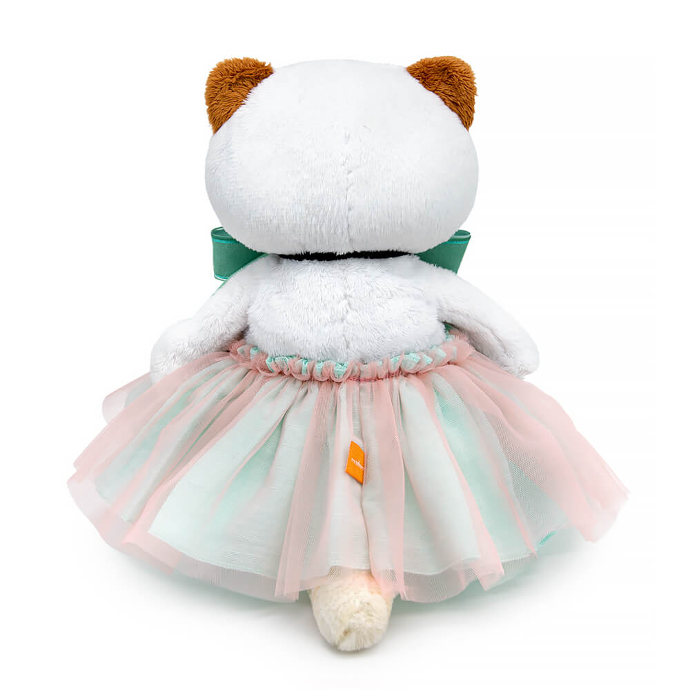 in a skirt and with a mint bow