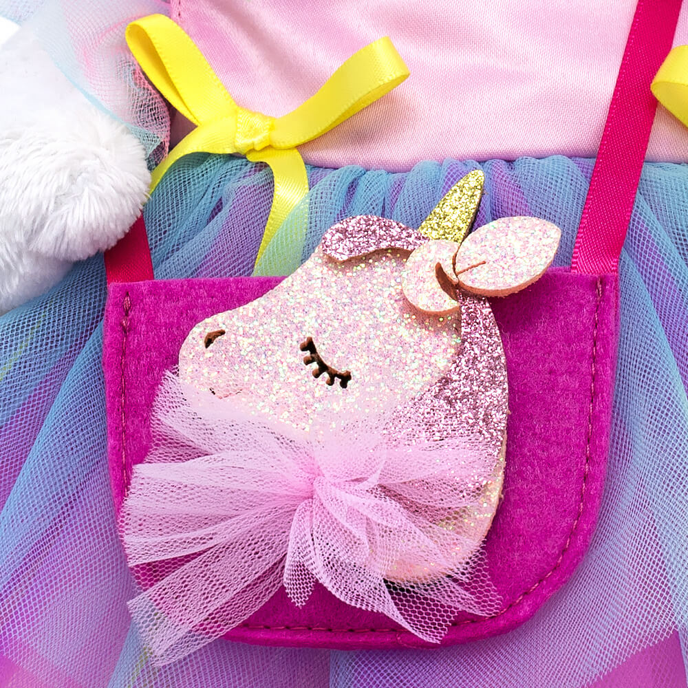 in a dress and a "Unicorn" handbag