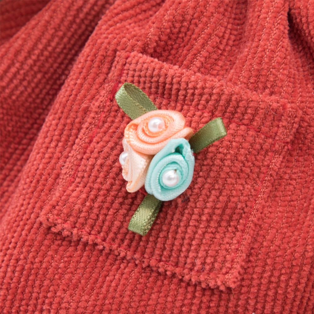 in a dress and apron with ruffles