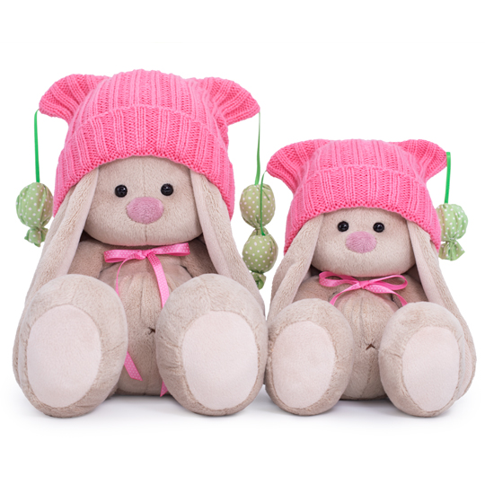 in a pink hat with pompons