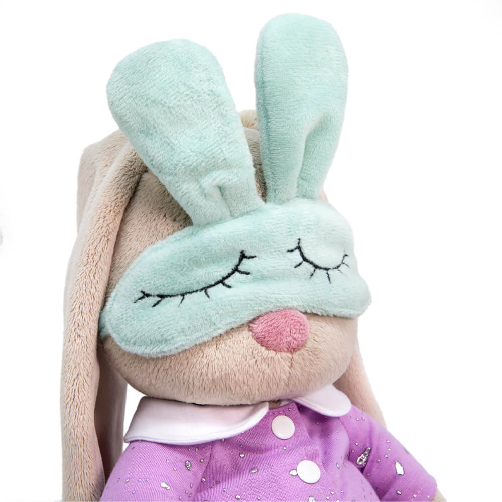 in pajamas with a sleep mask