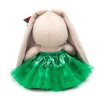 in a green skirt with a bow