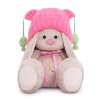 in a pink hat with pompons