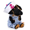 in a striped overalls and a panama hat with an anchor