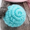 in a scarf and with a ball of wool