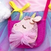 in a dress and a "Unicorn" handbag