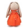 in an orange sundress with a bow