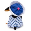 in a striped overalls and a panama hat with an anchor