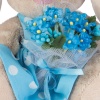 in a blue dress with a bouquet of forget-me-nots