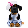 in a striped overalls and a panama hat with an anchor
