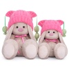 in a pink hat with pompons