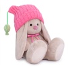 in a pink hat with pompons