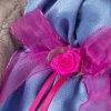 in blue dress with a rose bow